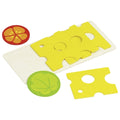 Cheese-shaped cutting board with yellow cheese slices and a tomato slice on a white background