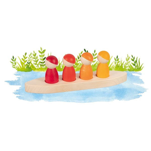 Colorful wooden toy figures on a boat with grass and water background