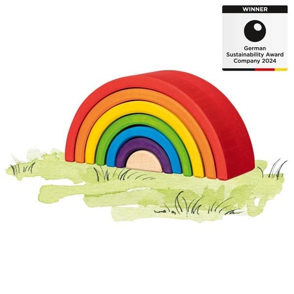 Colorful wooden rainbow toy on a grassy patch with a 'Winner' label for German Sustainability Award Company 2024.