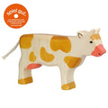 Wooden cow toy with a 'spiel gut' label on a white background