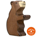Wooden bear figurine with 'spiel gut' certification label on a white background