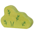 Green wooden toy bush with plant designs on a white background