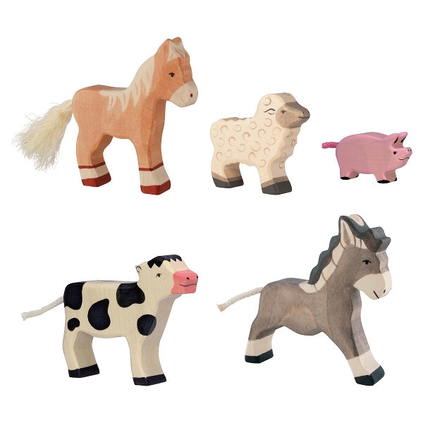 Set of wooden farm animal toys on a white background