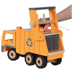 Wooden toy garbage truck with a hand pushing it, on a white background