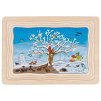 Wooden puzzle with a winter scene featuring a tree, birds, and children.