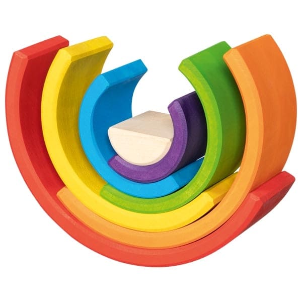 Colorful wooden toy rings stacked on a white background