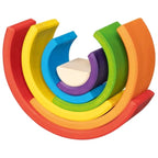 Colorful wooden toy rings stacked on a white background