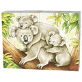 Three koalas on a branch with leaves in the background, featuring the brand 'Goki'.
