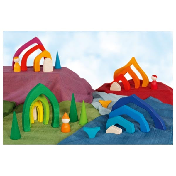 Colorful wooden toy landscape with various shapes and structures on a white background