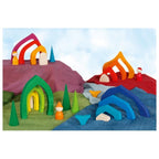 Colorful wooden toy landscape with various shapes and structures on a white background