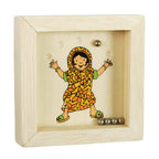 Wooden box with a colorful illustration of a child in a patterned dress, surrounded by small metallic objects.
