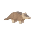 Wooden armadillo toy on a beige background