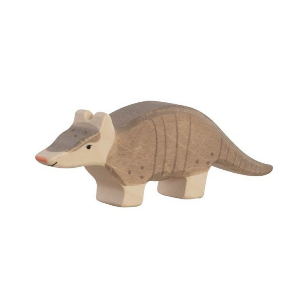 Wooden armadillo toy on a beige background