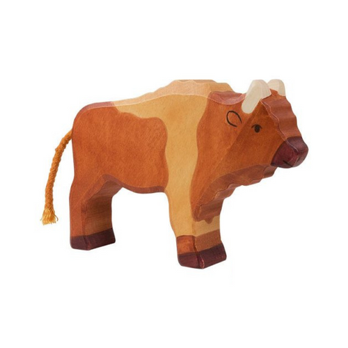 Wooden bull toy on a beige background