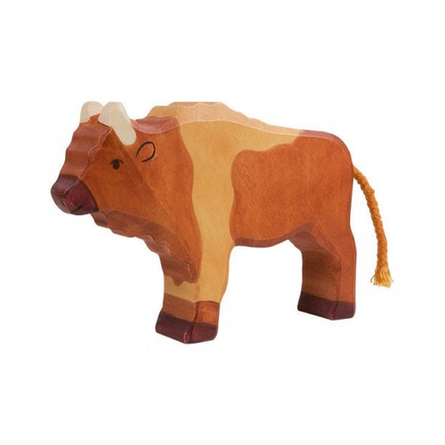Wooden bison toy on a beige background