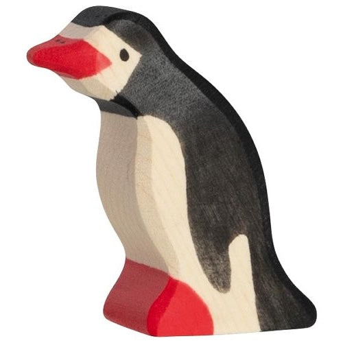 Small wooden penguin toy on a white background