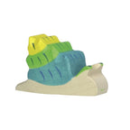 Toy snail figure with a green, blue and yellow shell on a white background