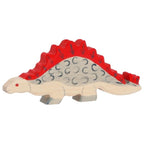 Wooden toy dinosaur with a red spiked back on a white background